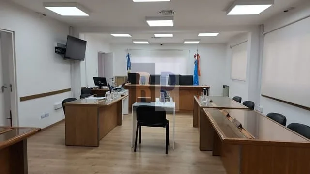 Tribunal de Juicio en Río Grande con sala vacía y bandera argentina