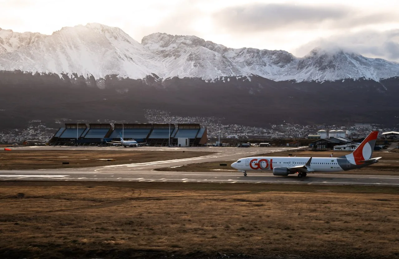 Avión de GOL aterrizando en el Aeropuerto Internacional de Ushuaia con montañas nevadas de fondo